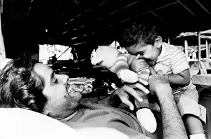 Fairgrounds: Cuban Refugee plays with son