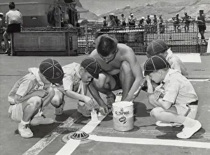 Practising: Cubs painting lines on ship