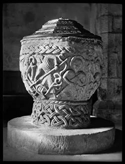Halos: Detail of a cup-shaped font carved with multiple scenes