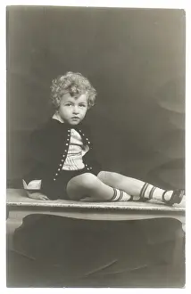 Sepia Images: Curly haired boy in photographer's studio