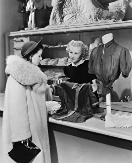 Shopper: Customer and clerk in clothing store