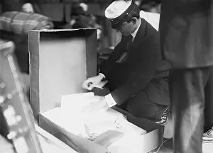 Tariffs: Customs officer inspecting luggage of a ?
