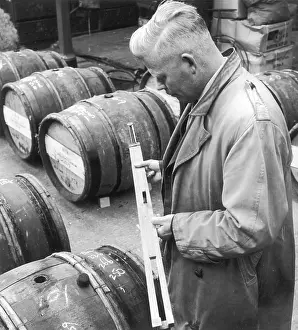 Measures: Customs Official checks the volume of wine in a barrel