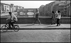 Vecchio: Cyclist, pedestrians, view of Ponte Vecchio, Florence, Italy