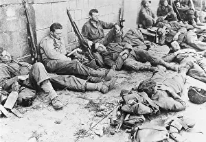 Exhaustion: D-Day - US Troops resting following initial assault