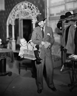 Fedora: Dad carrying son in basket