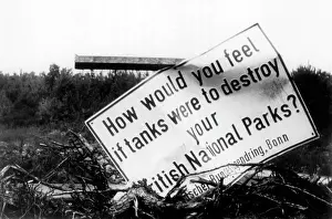 Adressed: Damaged sign against the devastation of nature by British tr
