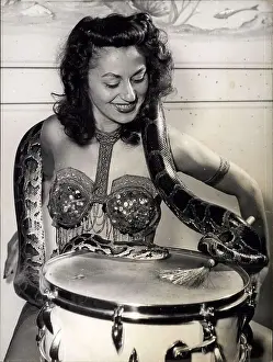 Kilogram: Dancer in costume with drum and python snake