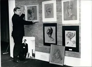 Arranges: Daniel Farson arranging Ward portraits