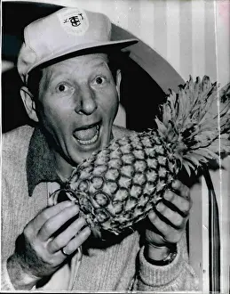 Impromptu: Danny Kaye, American actor, with pineapple