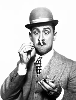 Incompetent: Dapper man having difficulty lighting his cigarette