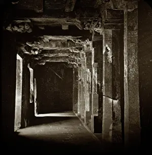 Ajanta: A dark corridor with many carved columns on each side