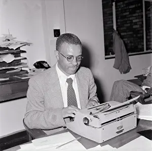 Ezekiel: NO DATE - Ezekiel Mphahlele, typing on a typewriter