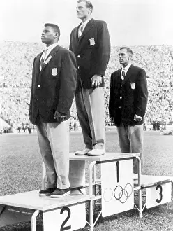 Decathlon: Decathlete Bob Mathias (center), receiving ?