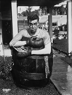 Frown: Defeated boxer in barrel outside