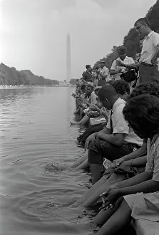 Minority: Demonstrators sit along the Reflecting Pool
