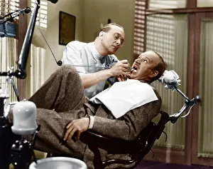 Ignore: A dentist working on a patient in the chair