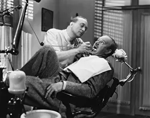 Dentistry: A dentist working on a patient in the chair