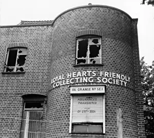 Pane: Derelict office building with broken windows, London