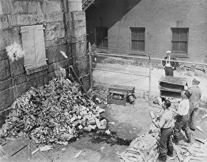 Destroying: Destroying bottles of alcohol during the time of Prohibition