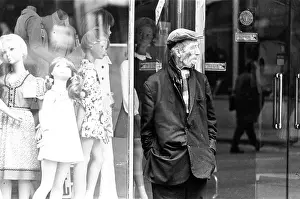 Dishevelled: A dishevelled man in front of clothes shop dummies