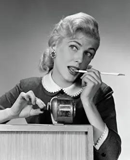 Distraction: Distracted blond woman office worker at pencil