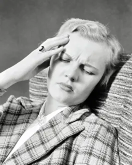 Pained: Distressed Blond Woman Hand to her Forehead
