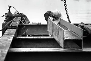 Girder: Docklands development, London, England - a welder at work