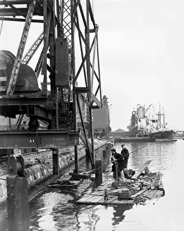 Robin Adler: Dockside scene with men on a raft, London