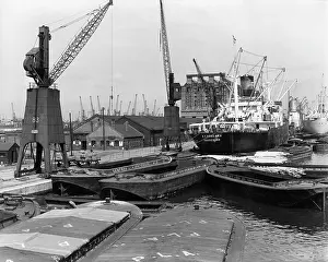 Robin Adler: Dockside scene with vessels and cranes, London