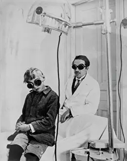 Therapy: Doctor and child patient with goggles during light therapy