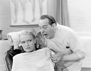 Scream: Doctor shouting into the ear of a patient