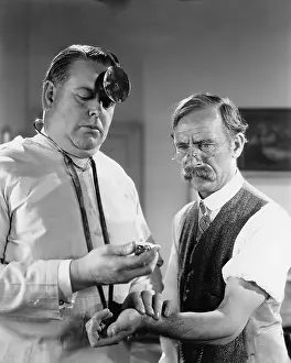 Mustaches: Doctor taking mans pulse