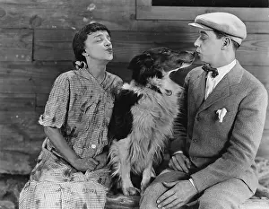 Dog in middle of couples kiss