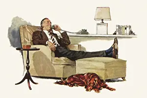 Repose: Dog sits next to Man on Phone