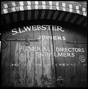 Hinges: Detail of the doorway to the premises of S. L