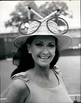 Rackets: Doreen Dawn in tennis racket hat at Wimbledon