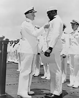 Cited: Doris Dorie Miller (1919-1943), receives ?