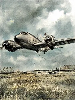 Swooping: Douglas Dakota picking up a glider, Normandy; Second World W