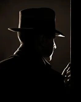 Larceny: Dramatic Rear Profile of Man in Fedora Peeking