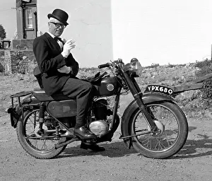 Pinstriped: Well dressed man on a motorcycle