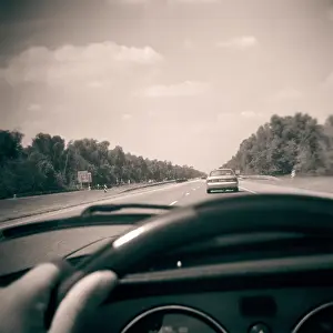 Dashboard: Driver View of Highway Over Automobile Dashboard Hand on S
