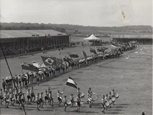 Drumming: Dutch boy scouts on a parade ground with flags