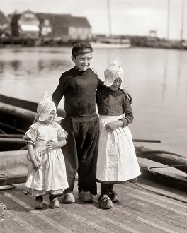 Clog: Dutch Boy Standing with his Arms Around Two Sisters