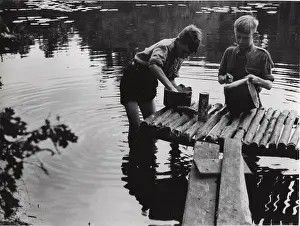 Tins: Dutch scouts washing up in a river, Holland