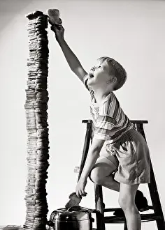 Misconduct: Eager Boy Standing on Step Ladder Reaching the