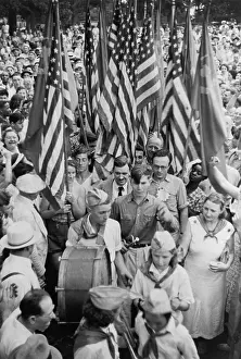 Earl Browder surrounded by people at a Communist