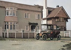 Clapboard: Early car parked in front of house