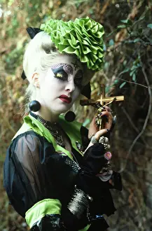 Sequinned: Ecentric lady holding a Crucifix