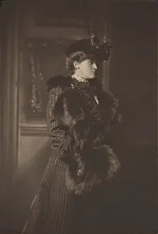 Wharton: Edith Wharton, wears a feathered hat, a fur-trimmed
